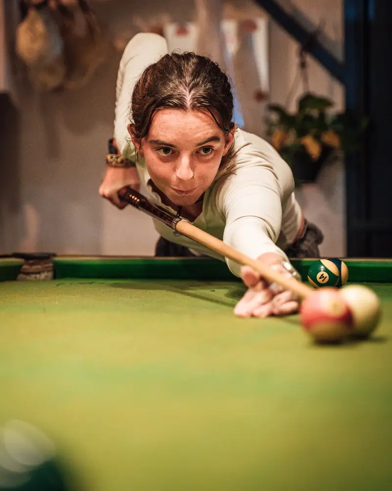 A guest lining up a shot at the Hiriketiya pool table